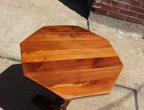 A small walnut side table with big problems